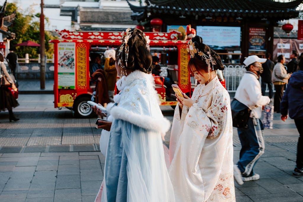 People in traditional attire on a vibrant street in Nanjing, capturing a moment of Chinese culture.